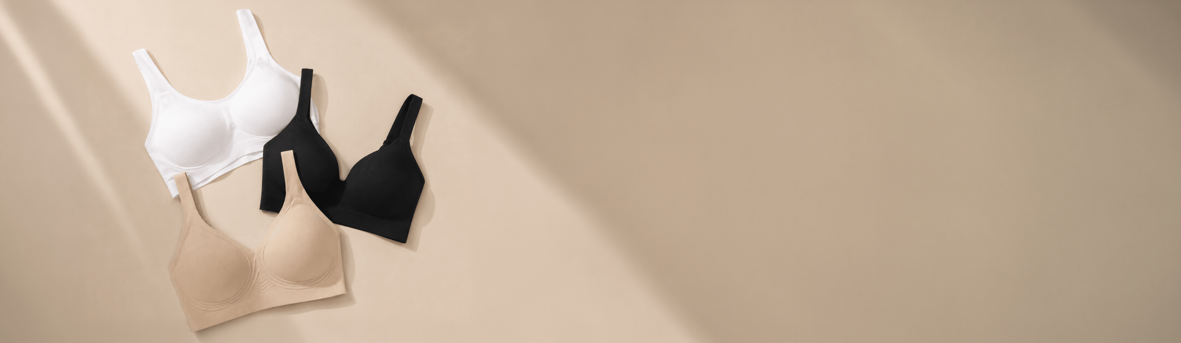 Truekind bras in black, tan, and white